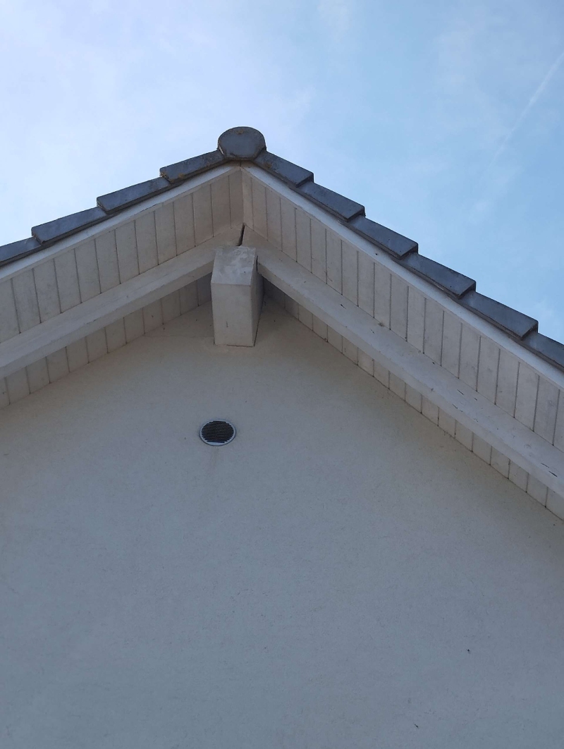Nahe dem Dachgiebel in Lauwil weist eine oeffnung auf ein moegliches Wespennest hin, das einen Kammerjaeger erforderlich machen koennte.